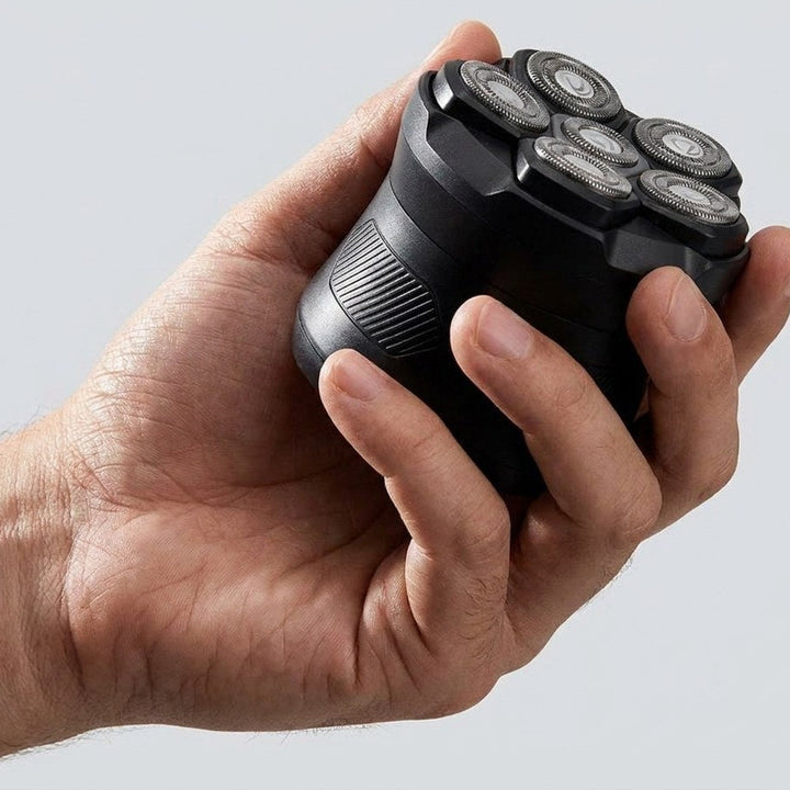 Kompakt rakapparat i handflatan visar det ergonomiska greppet