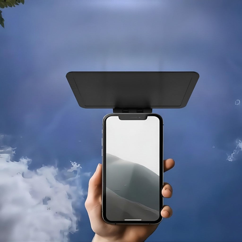 Vikbar solskyddsskärm för mobil – hålls i handen mot blå himmel
